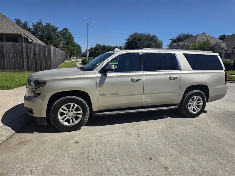 Gold 2015 Chevrolet Suburban LT side profile near Houston TX