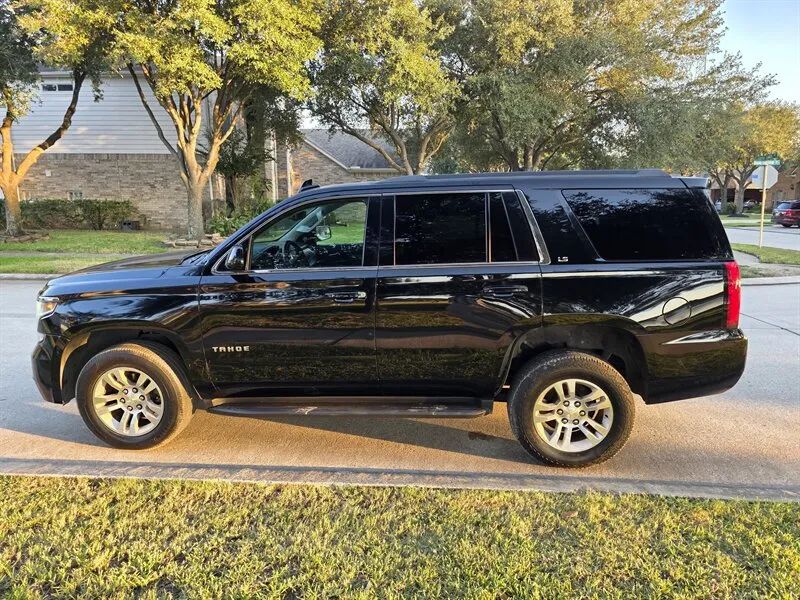 Used Chevrolet Tahoe SUV side profile at Essence Autos near Houston TX