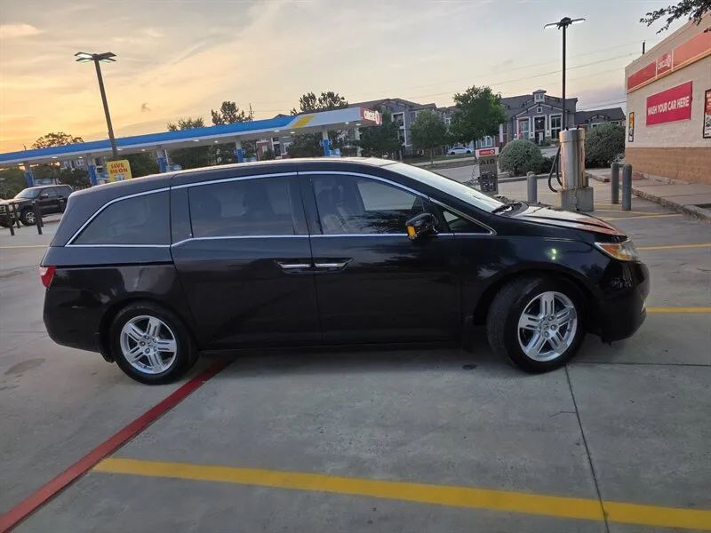 Black 2013 Honda Odyssey Touring Elite side profile near Houston TX